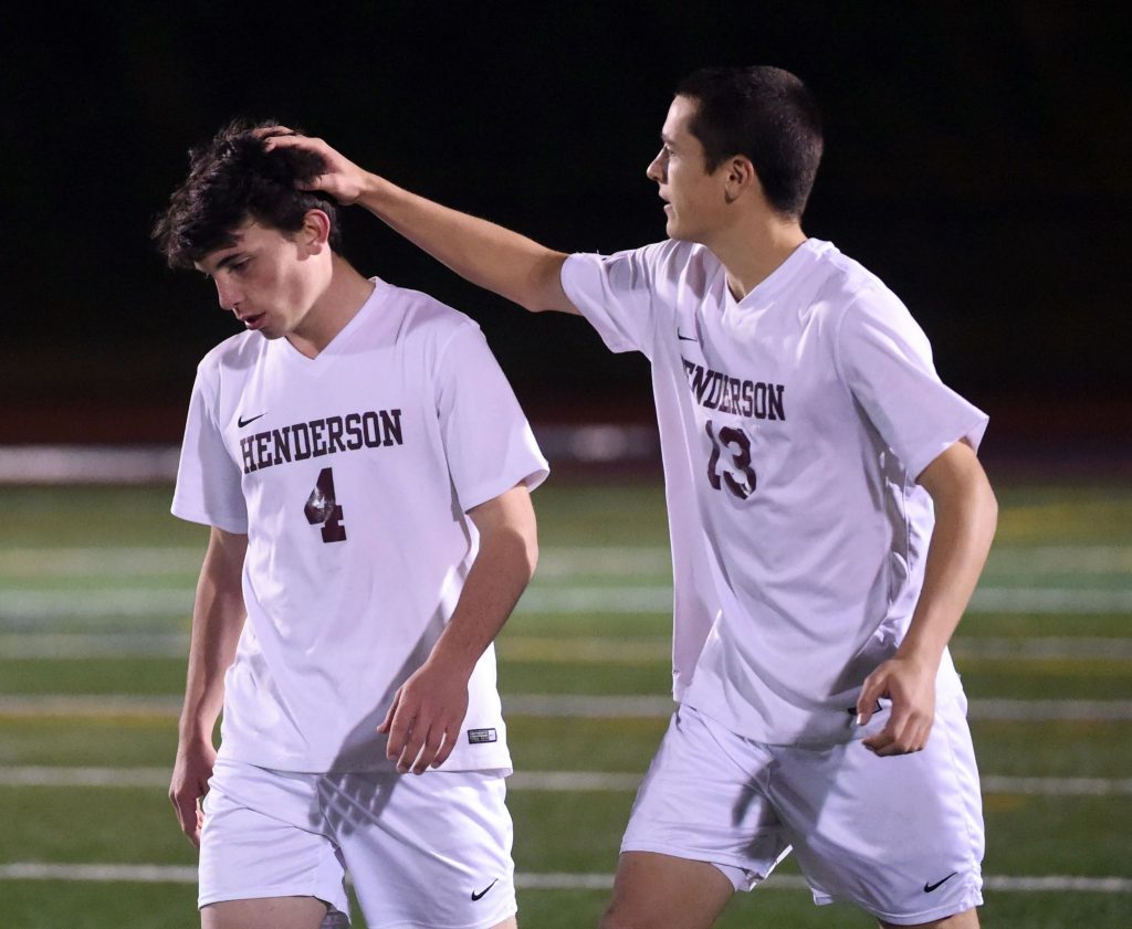 PETE  BANNAN-DIGITAL FIRST MEDIA     Henderson soccer player Frank DeRosa consoles Charlie Collins after his shot was stopped in a shootout in the semifinals against Elizabethtown at Exeter High School Tuesday evening.